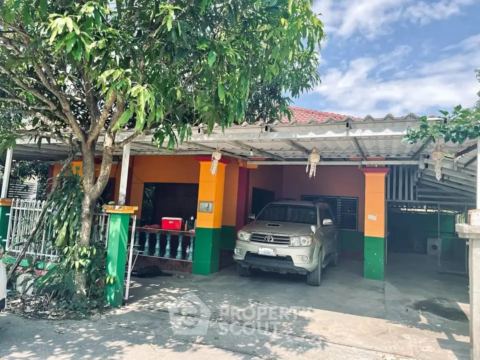 Charming residential property with carport and lush greenery in a serene neighborhood.