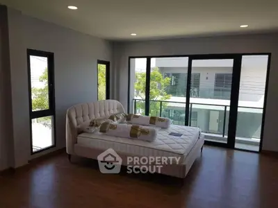 Spacious bedroom with large windows and balcony access in modern home