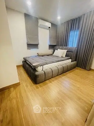 Modern bedroom with stylish decor and wooden flooring