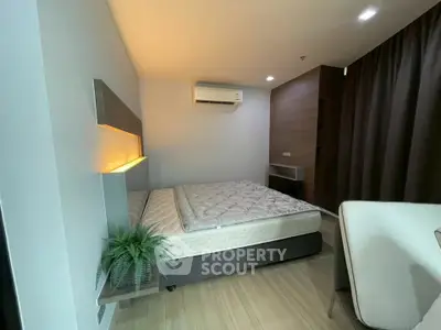 Modern bedroom with stylish lighting and air conditioning in a cozy apartment.