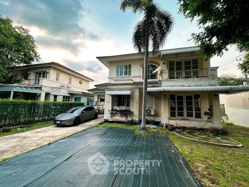 Charming two-story house with spacious driveway and lush greenery, perfect for family living in a serene neighborhood.