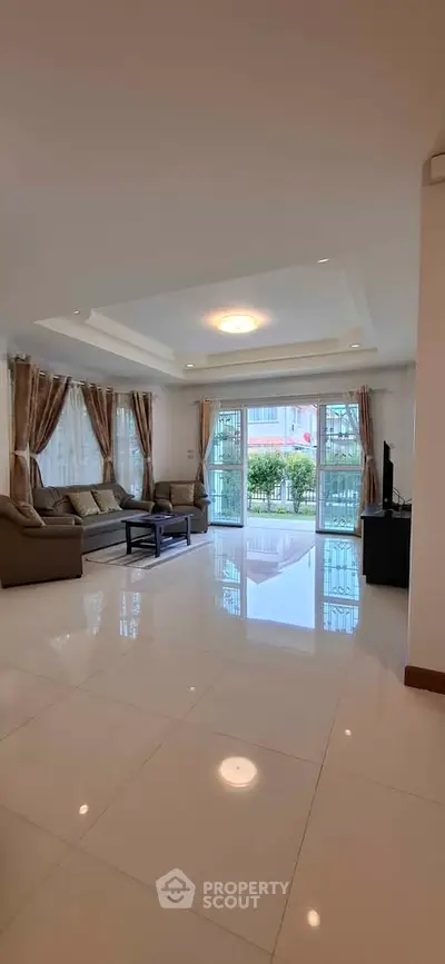 Spacious living room with elegant decor and large windows for natural light.