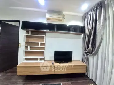 Modern living room with sleek TV unit and stylish shelving