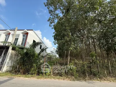 Modern corner unit townhouse with lush greenery and spacious surroundings