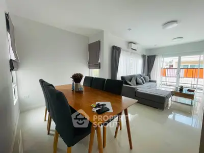 Spacious modern living room with elegant dining area and cozy seating, perfect for family gatherings.