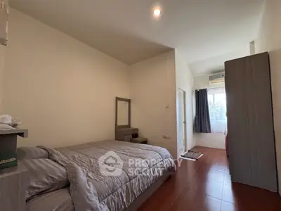 Spacious bedroom with modern furnishings and natural light, perfect for comfortable living.