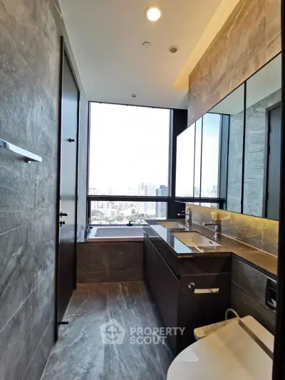 Luxurious bathroom with city view, modern fixtures, and elegant stone finishes.