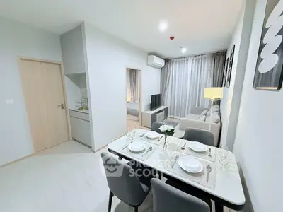 Modern open-plan living and dining area with stylish decor and natural light