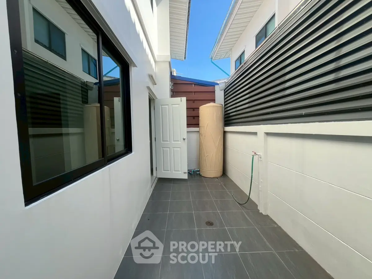 Modern exterior with sleek design and water tank, perfect for efficient living.