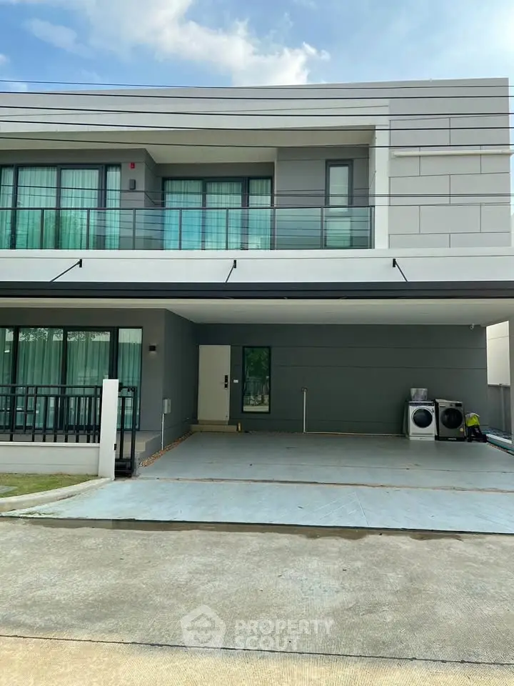 Modern two-story house with spacious driveway and laundry area