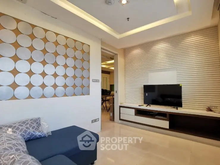 Modern living room with stylish wall decor and sleek TV setup