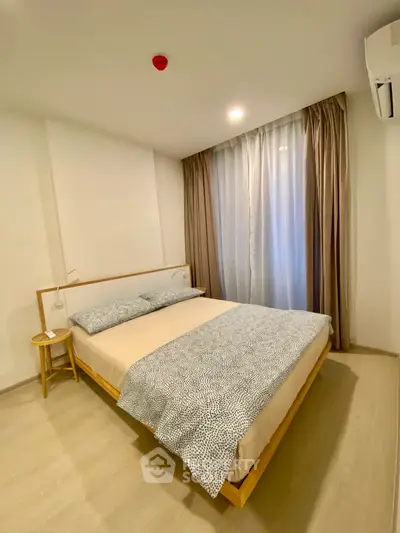 Modern minimalist bedroom with cozy bed and natural light