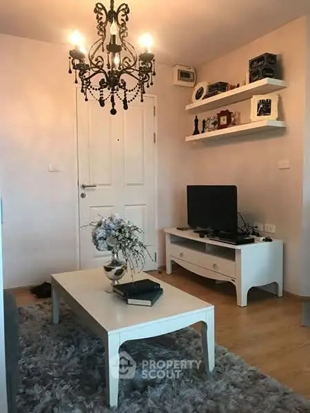 Charming living room with elegant chandelier and cozy decor