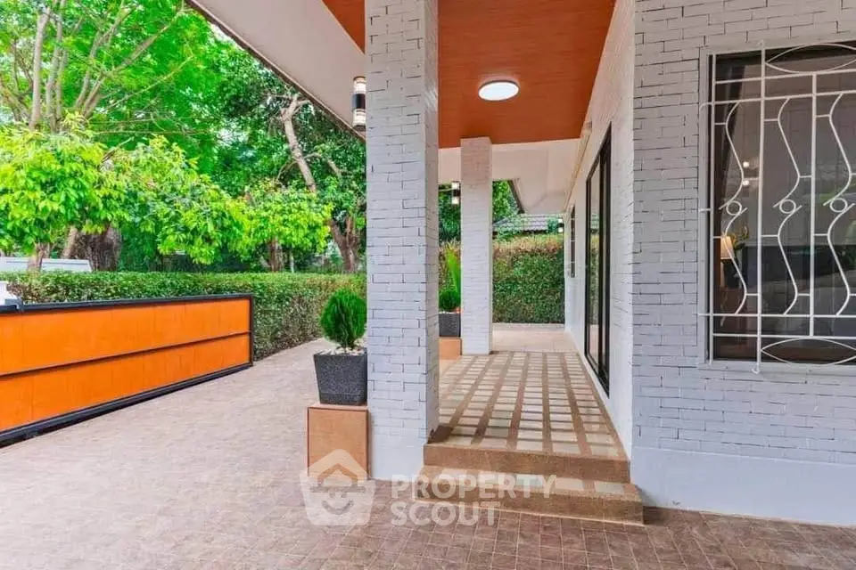 Modern home exterior with stylish brickwork and lush green surroundings.
