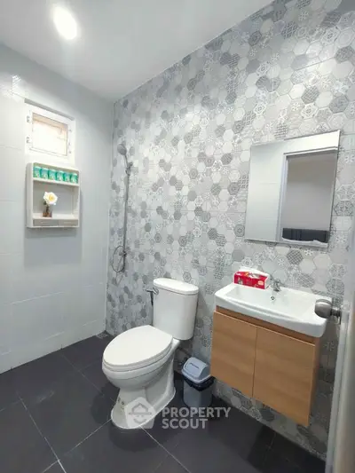 Modern bathroom with stylish tile design and compact fixtures