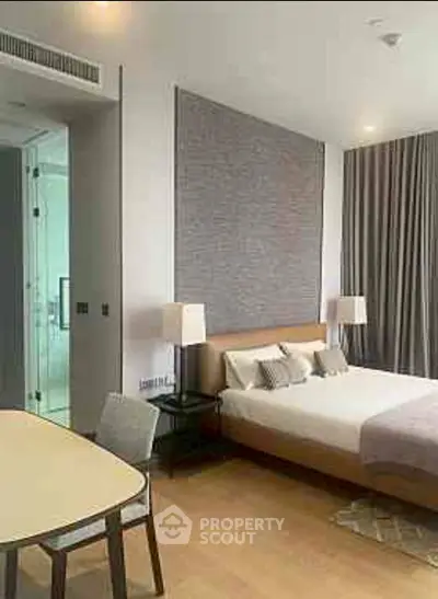 Modern bedroom with stylish decor and cozy ambiance, featuring a comfortable bed and elegant lighting.