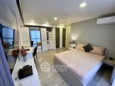 Modern bedroom with stylish decor and ample storage in a cozy apartment.