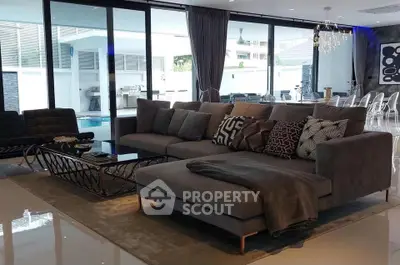 Luxurious modern living room with pool view and stylish decor