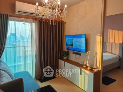 Modern living room with chandelier and city view, featuring elegant decor and cozy ambiance.