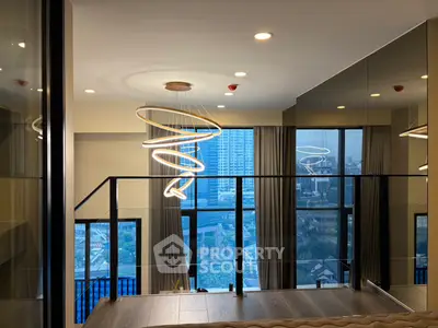 Luxurious modern living room with stunning city view and elegant lighting fixtures.