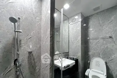 Luxurious modern bathroom with sleek marble tiles and high-end fixtures.