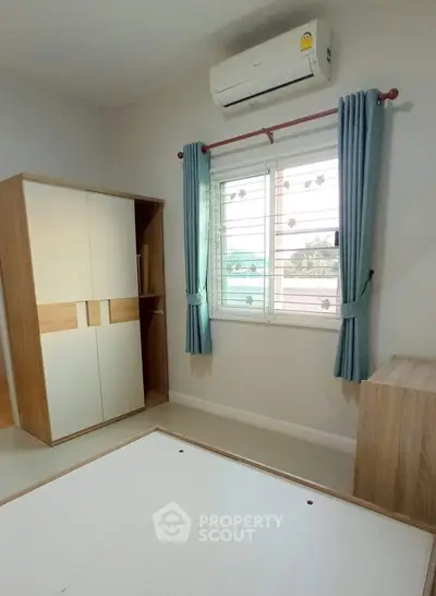 Bright bedroom with air conditioning and modern wardrobe