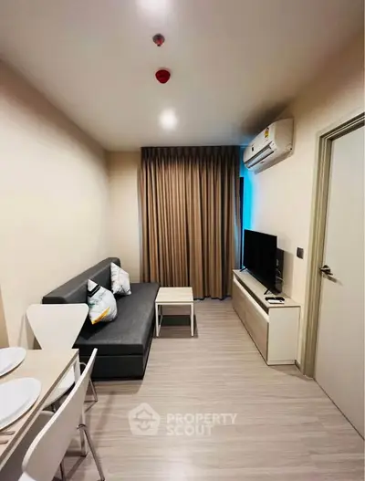 Modern living room with sleek furniture and air conditioning in a cozy apartment.