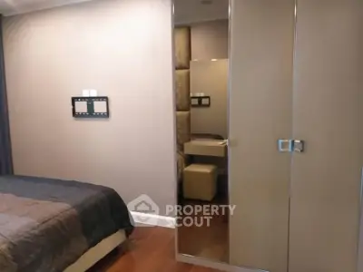 Modern bedroom with mirrored wardrobe and cozy decor