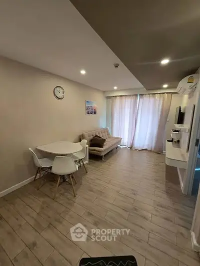 Modern living room with wooden flooring and cozy furniture