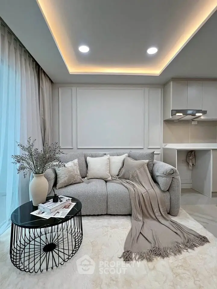 Modern living room with cozy gray sofa, elegant decor, and ambient lighting in a stylish apartment.