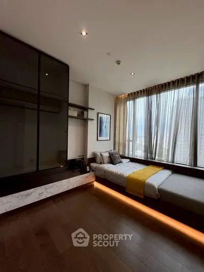 Modern bedroom with floor-to-ceiling windows and stylish decor in a high-rise apartment.