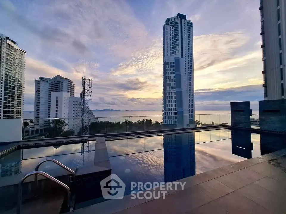 Stunning rooftop pool with breathtaking city and ocean views at sunset