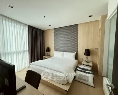 Modern bedroom with stylish decor and natural light