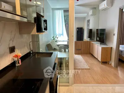 Modern open-layout kitchen and living room with sleek appliances and stylish decor