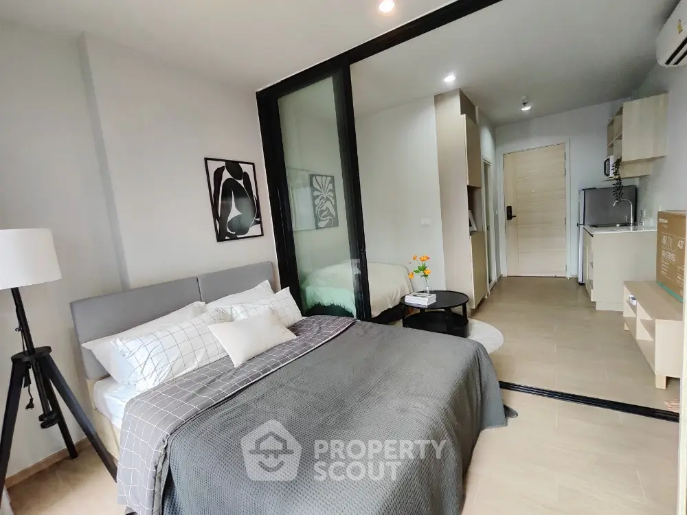 Modern studio apartment with stylish decor and compact kitchen