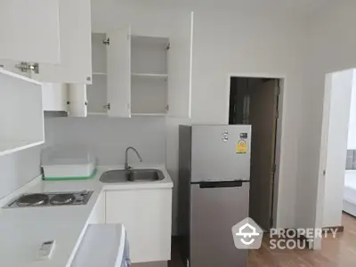 Modern kitchen with stainless steel fridge and ample storage space