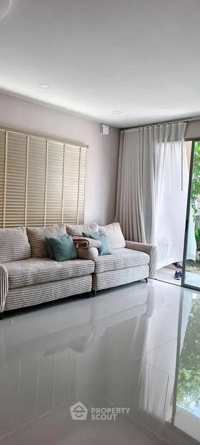 Spacious living room with modern decor and large windows for natural light.