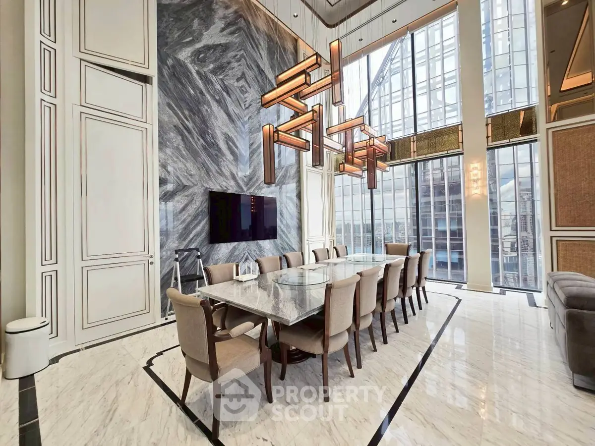 Luxurious dining area with marble flooring and modern chandelier in high-rise apartment
