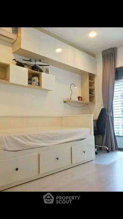 Modern bedroom with built-in storage and sleek design, perfect for maximizing space in urban living.
