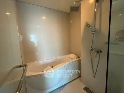 Luxurious bathroom with modern bathtub and shower, perfect for relaxation.