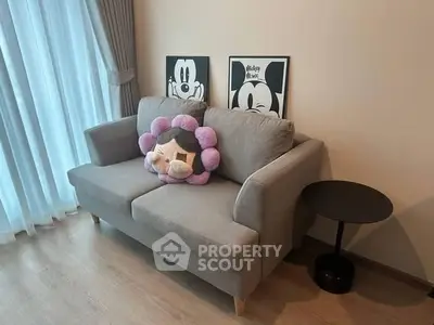 Cozy living room with stylish sofa and playful decor, perfect for relaxation and entertainment.