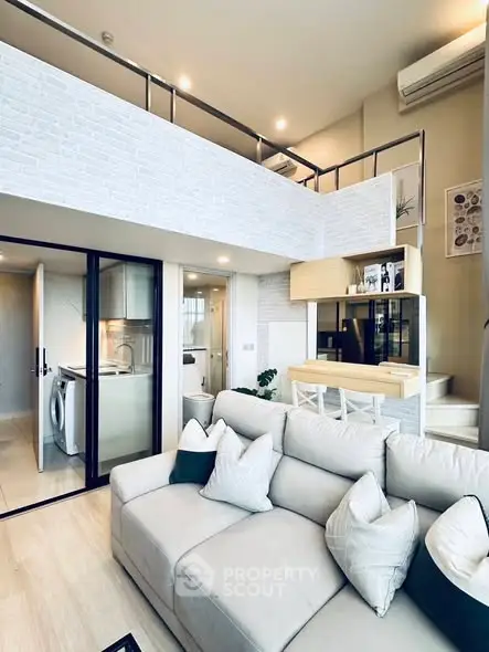 Modern loft apartment with stylish living room and open kitchen layout.