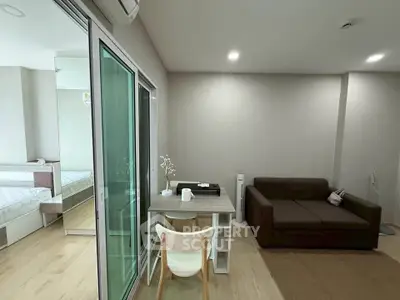 Modern studio apartment with cozy living area and sliding glass doors
