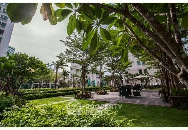 Lush garden area with seating in modern residential complex