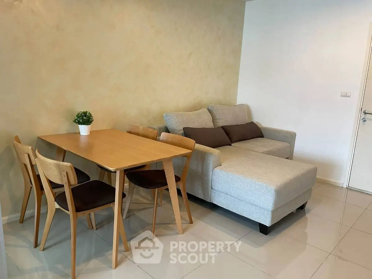 Modern living room with cozy sofa and dining table in stylish apartment