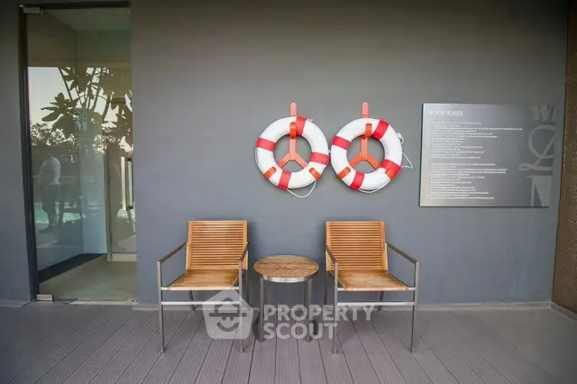 Stylish poolside seating area with chairs and life rings, perfect for relaxation.