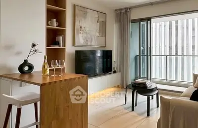 Modern living room with stylish decor and balcony access in urban apartment.