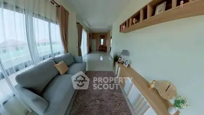 Spacious living room with modern decor and large windows offering natural light.