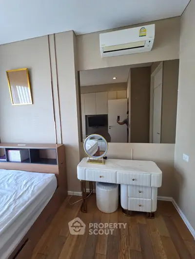 Modern bedroom with stylish vanity and air conditioning in a contemporary apartment.