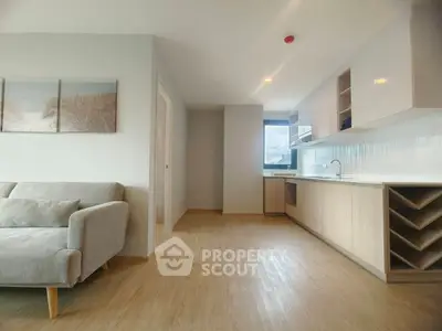 Modern open-layout kitchen and living room with sleek design and natural light